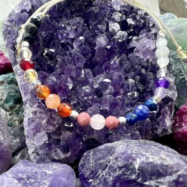 Zbliżenie bransoletki Światła Czakr w złotych detalach.